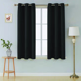 Front view of black microfiber blackout curtains in a living room