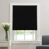Black thermal blackout roller blind fully extended on a window