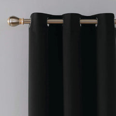 Close-up of silver eyelets on black blackout curtain panel
