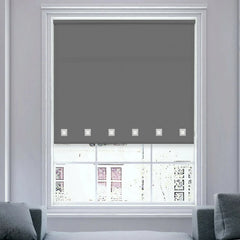 Charcoal square eyelet roller blinds fully covering a window, filtering natural daylight with a sleek, modern look.