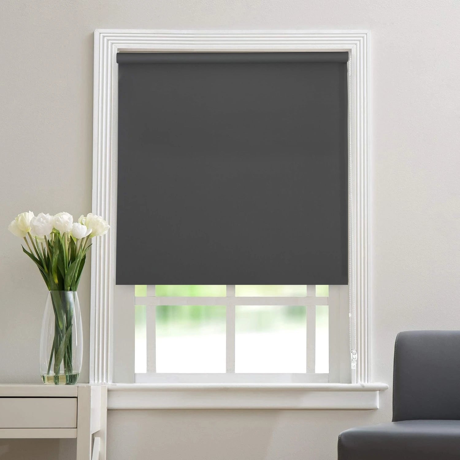Light grey thermal blackout roller blind fully unrolled on a window