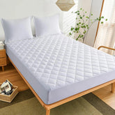 Soft microfiber mattress protector on a neatly made bed