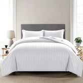 Microfiber satin stripe duvet cover set with pillowcases displayed on a bed