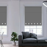 Stylish modern interior with charcoal square eyelet roller blinds gently diffusing natural light.