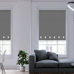 Stylish modern interior with charcoal square eyelet roller blinds gently diffusing natural light.