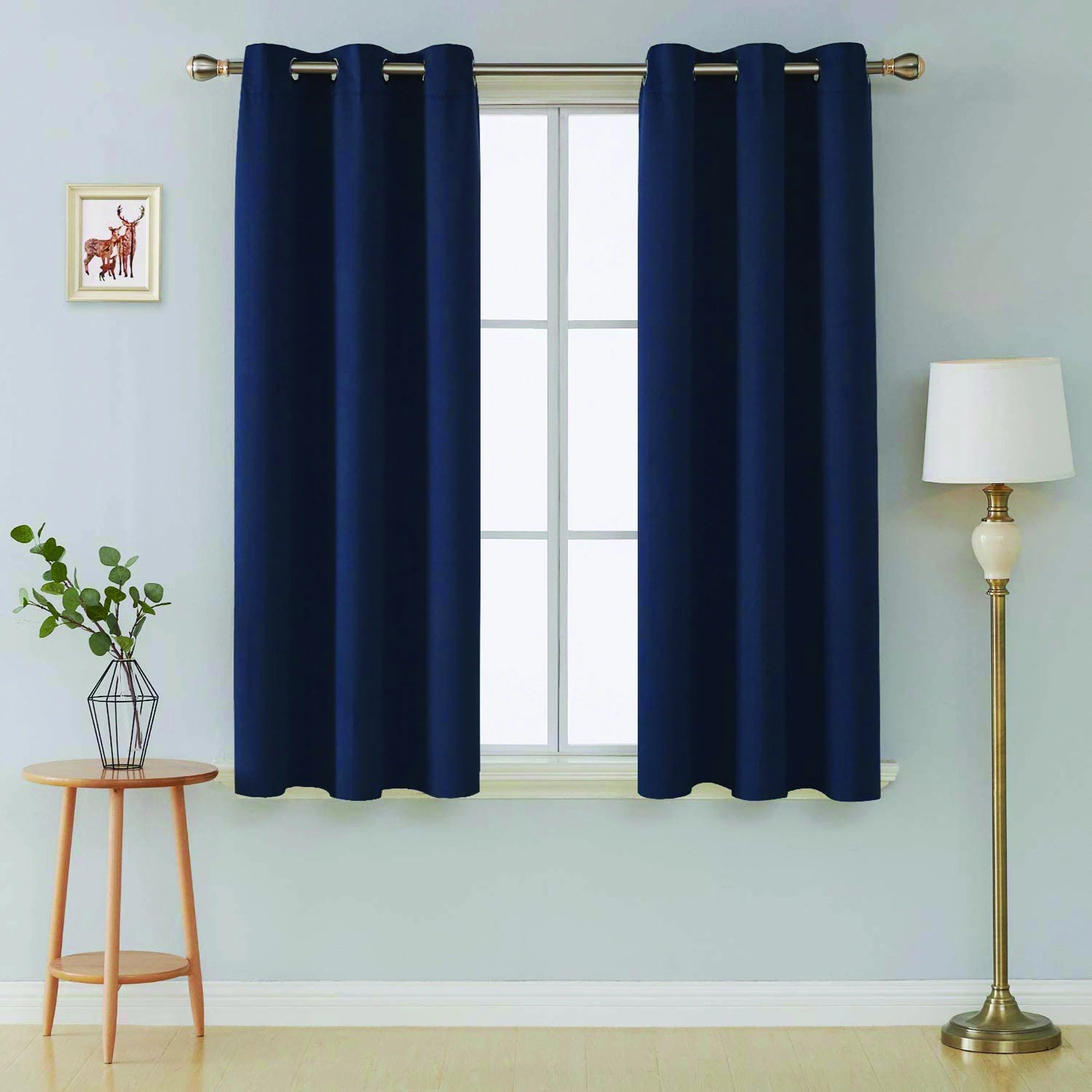 Front view of navy blue microfiber blackout curtains in a modern room