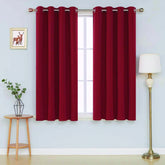 Front view of red microfiber blackout curtains hanging in a stylish room