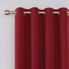 Close-up of metal eyelets on red blackout curtain panel