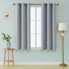 Front view of silver microfiber blackout curtains hanging in a modern room