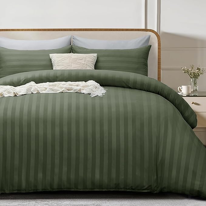  Olive Green striped bedding set on a bed with pillows and a nightstand in the background.