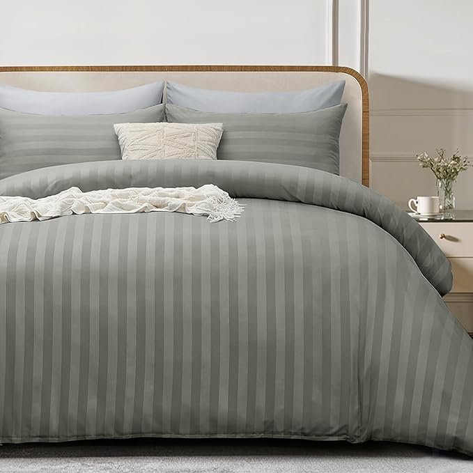charcoal striped bedding set on a bed with a wooden headboard.