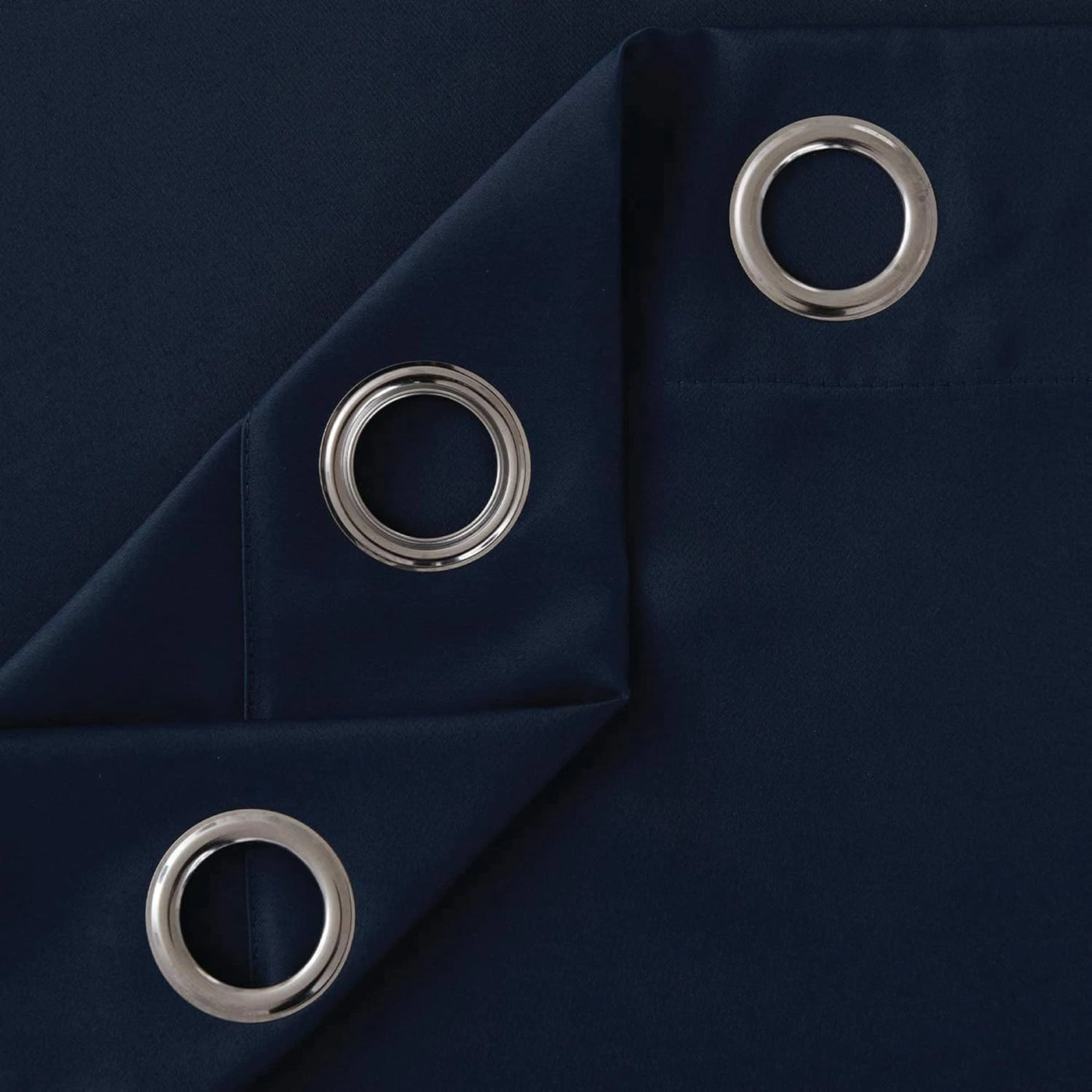 Folded navy blue microfiber blackout curtains showing texture and stitching