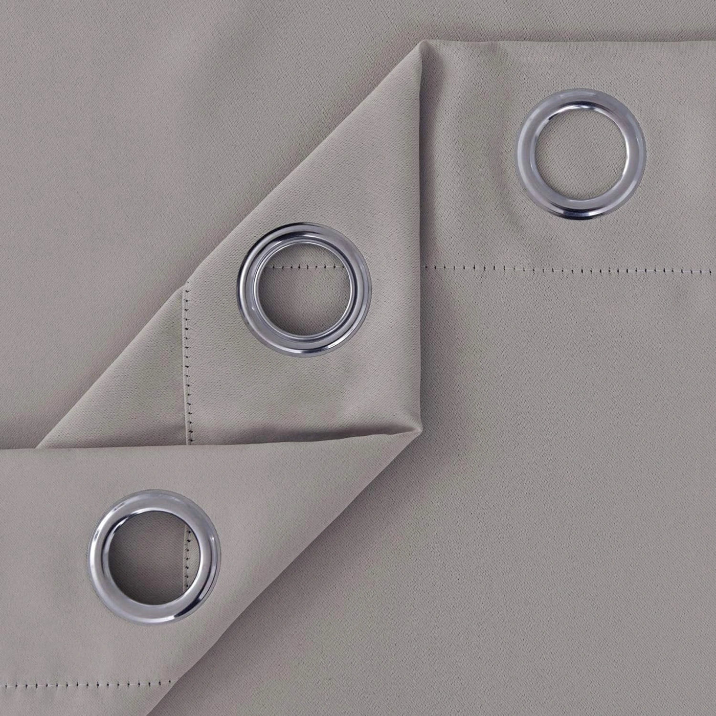 Folded silver microfiber blackout curtain showing fabric and stitching quality
