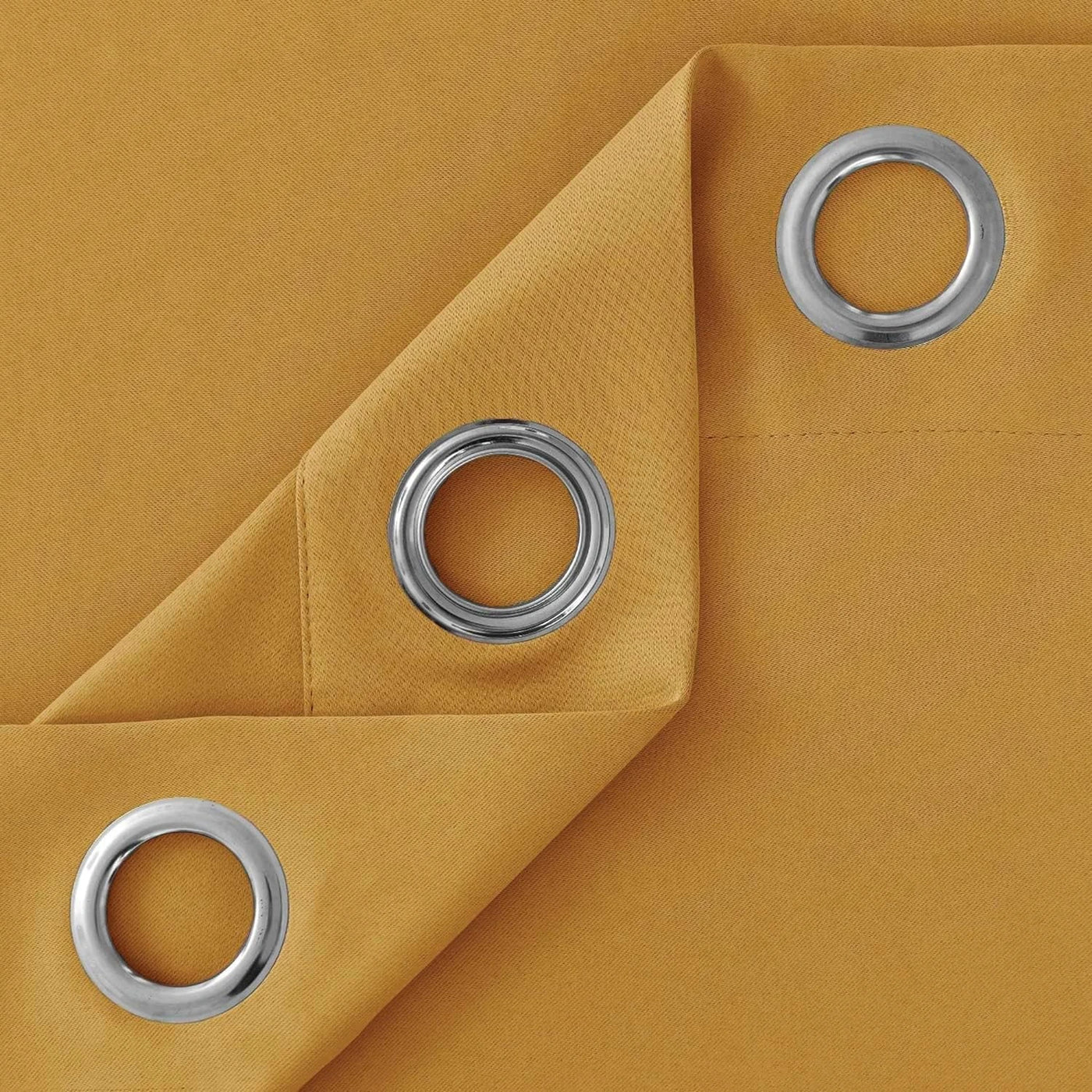 Machine-washable ochre blackout curtains shown with care label