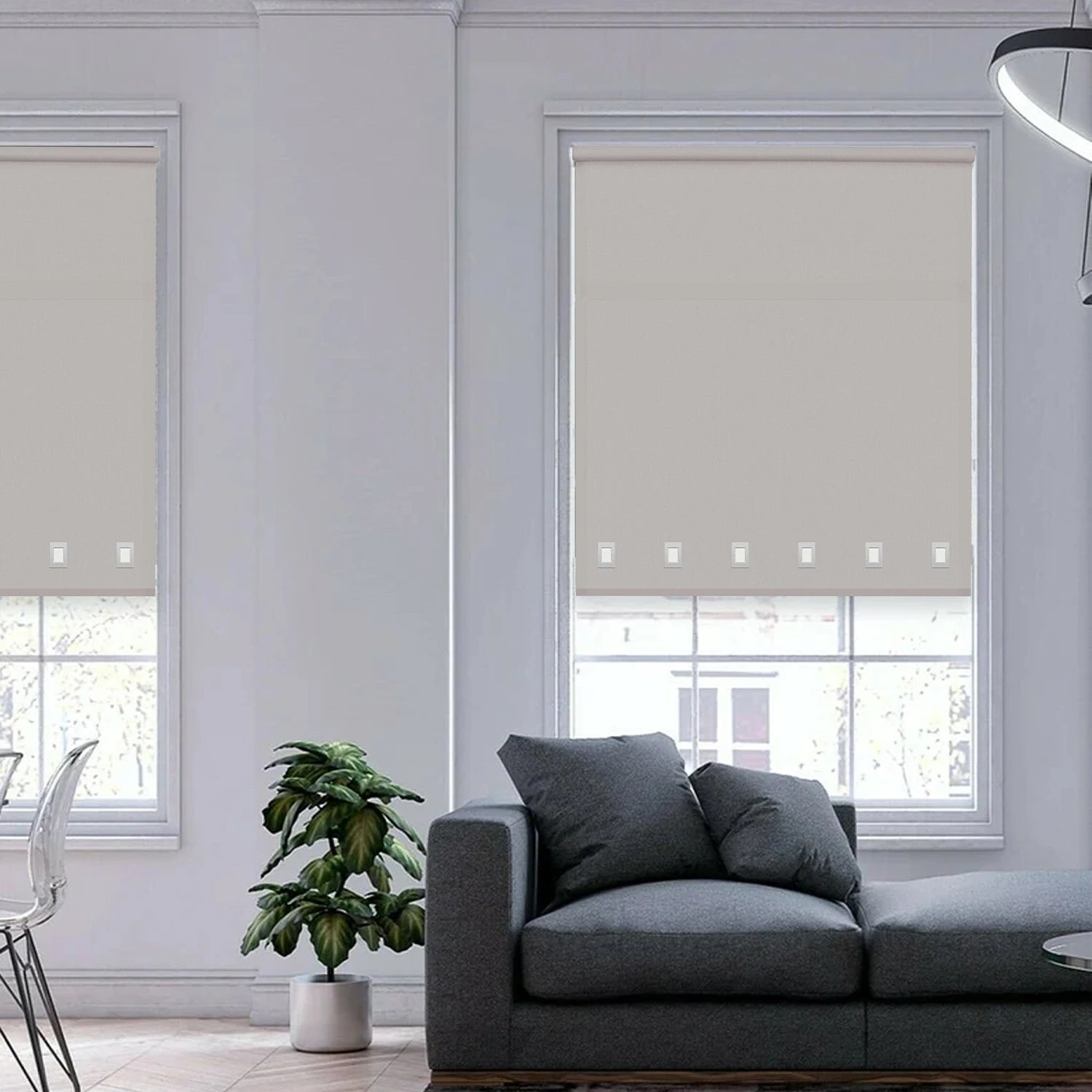 Modern interior featuring light grey square eyelet roller blinds filtering sunlight through large windows.