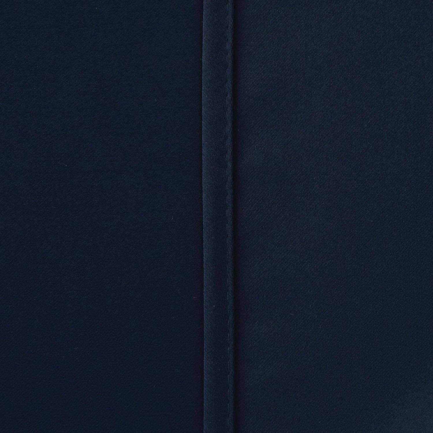 Navy blue blackout curtains styled with matching tie backs