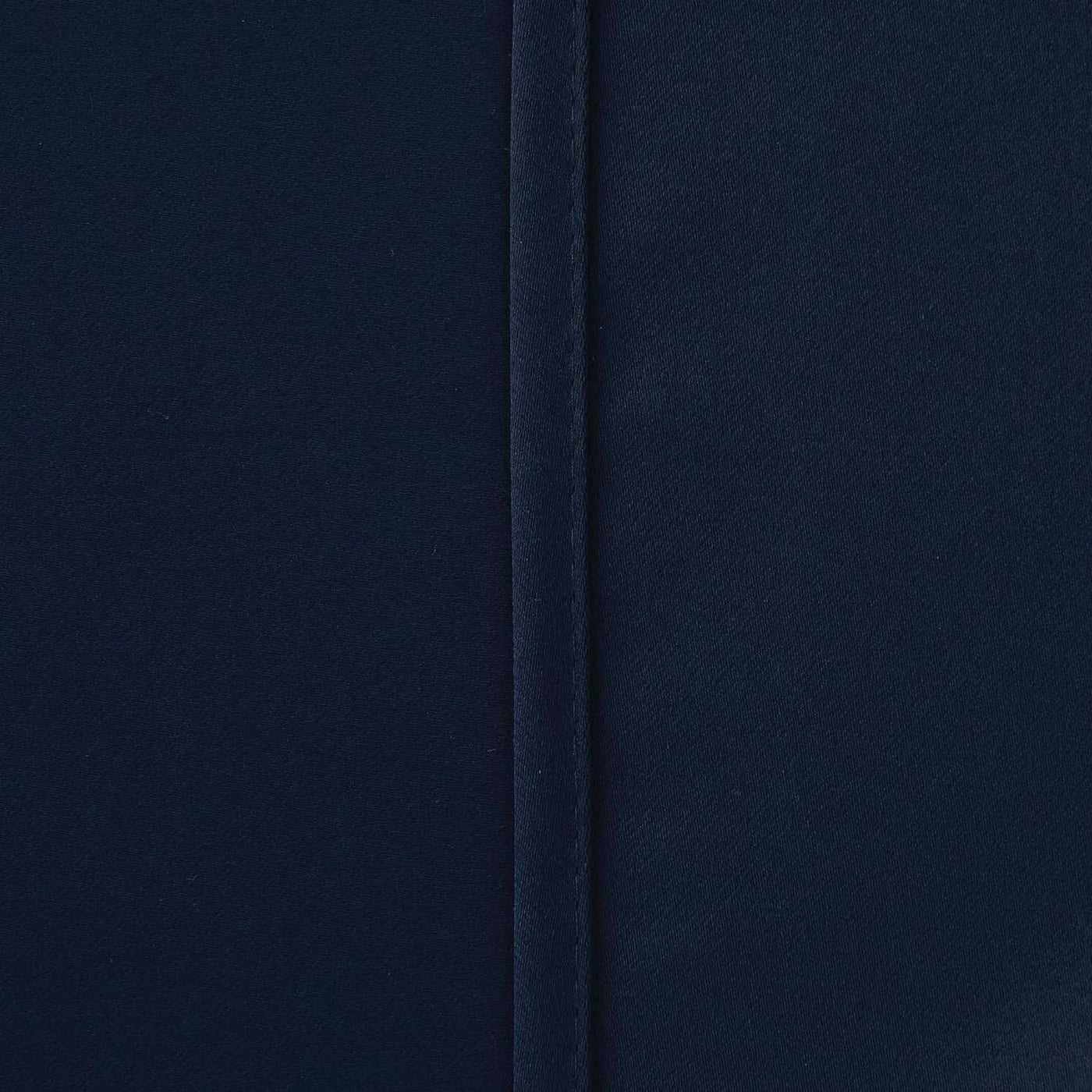 Navy blue blackout curtains styled with matching tie backs