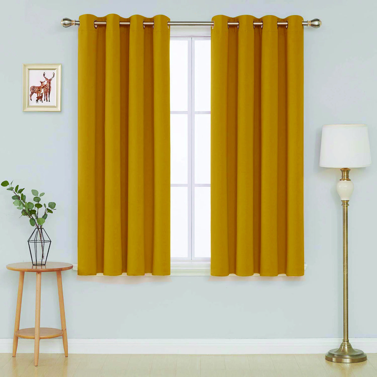  Front view of ochre microfiber blackout curtains hanging in a living room