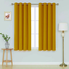  Front view of ochre microfiber blackout curtains hanging in a living room