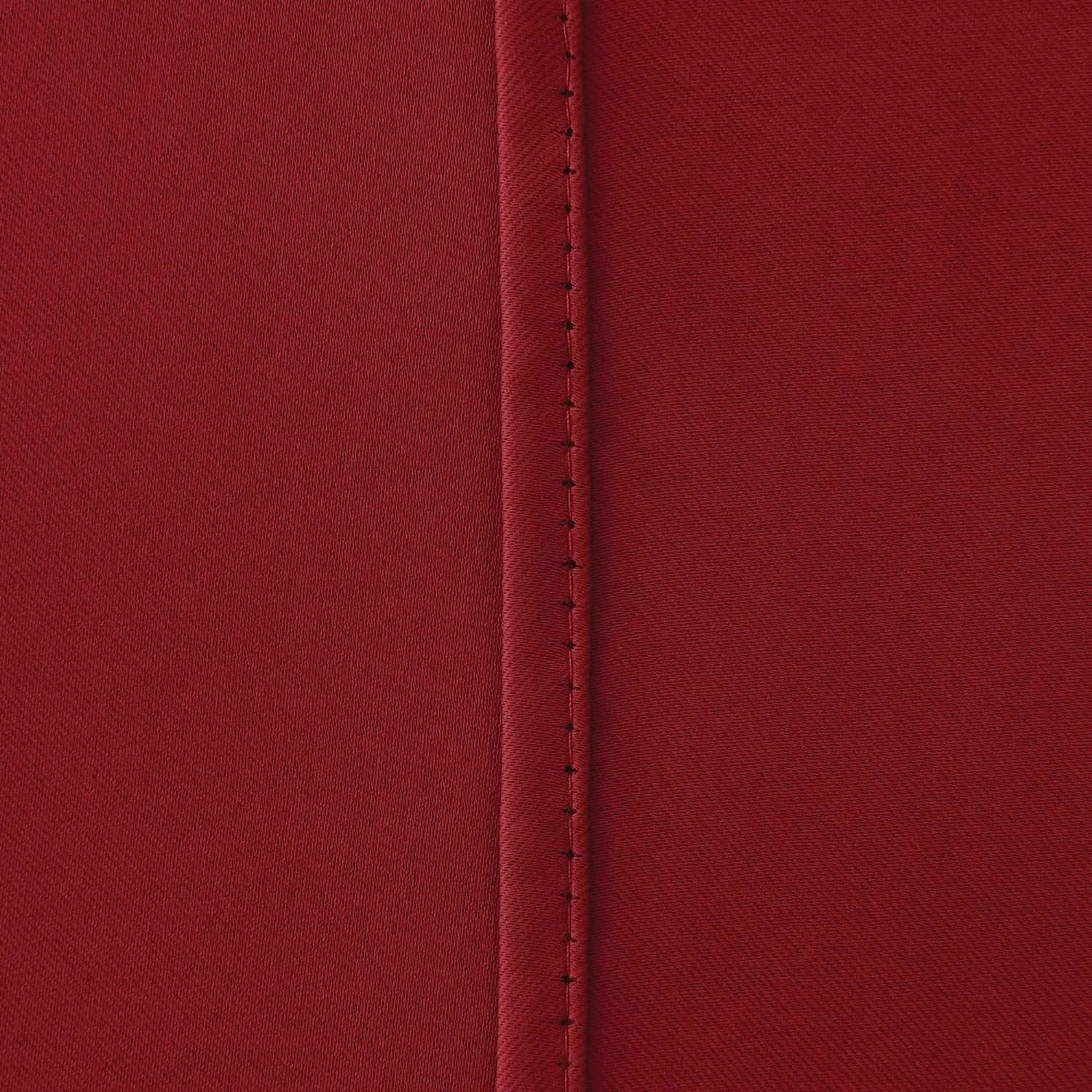  Red blackout curtains pulled back with matching tie backs
