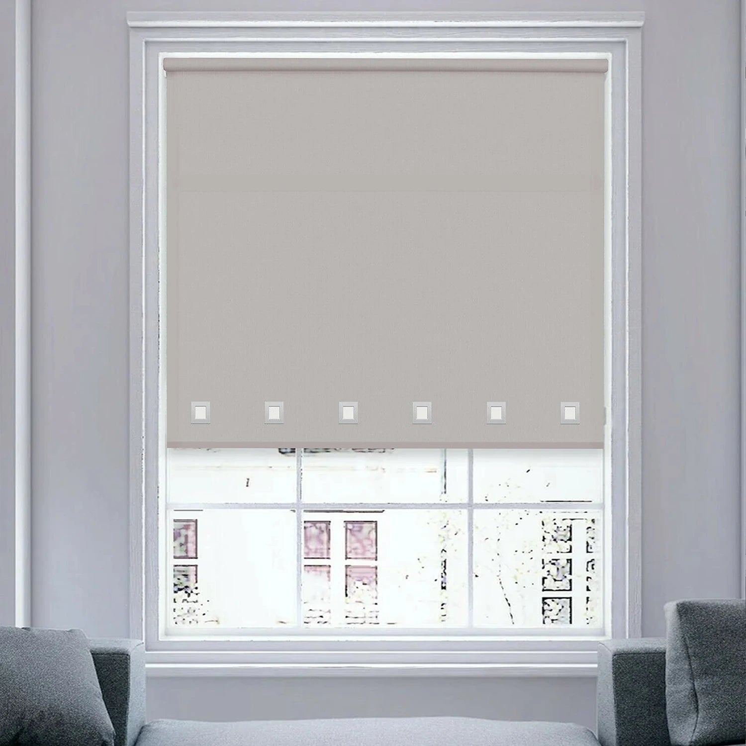 Close-up view of light grey roller blind fabric with square eyelet detail.
