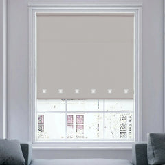 Close-up view of light grey roller blind fabric with square eyelet detail.
