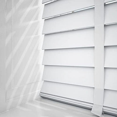 Side angle of white faux wood blind showing control cords and tilt mechanism